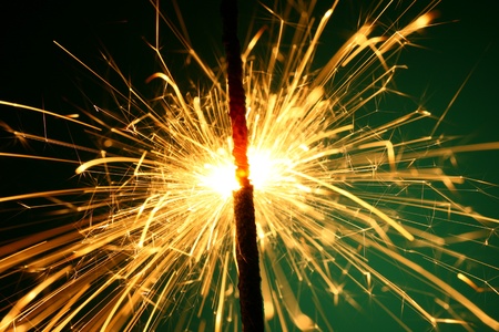christmas sparkler on green backgroundの写真素材