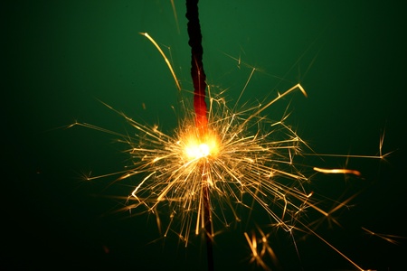 christmas sparkler on green backgroundの写真素材