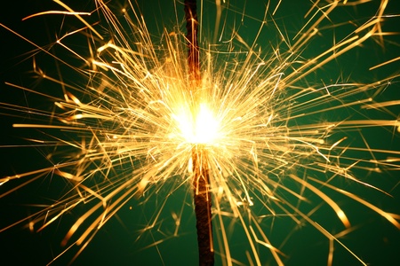 christmas sparkler on green backgroundの写真素材