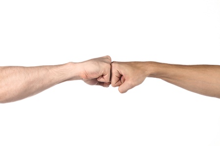 Two fists beat each other meet in a pointの写真素材