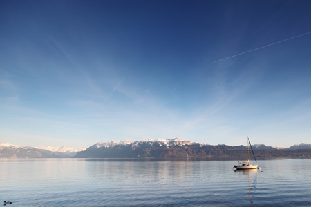 yacht in lake of geneva landscape on sunriseの写真素材