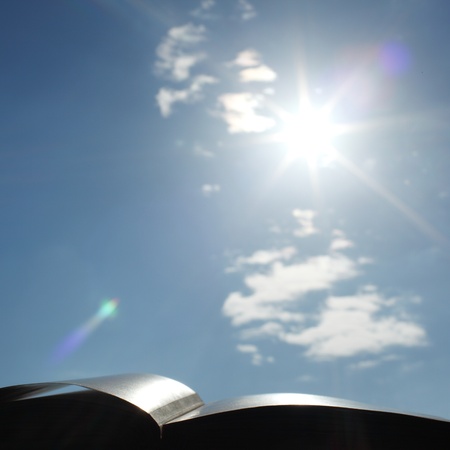 book of wisdom on sun sky backgroundの写真素材