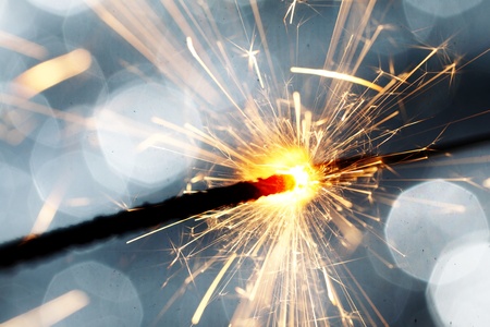 sparkler on silver bokeh background macro close upの写真素材