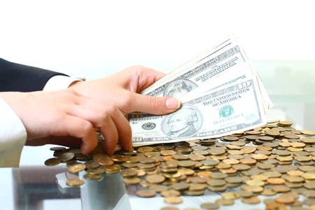hands counting dollar money on white backgroundの写真素材