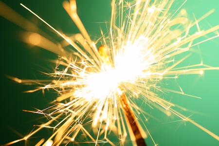 christmas sparkler on green backgroundの写真素材