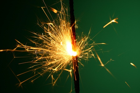 christmas sparkler on green backgroundの写真素材