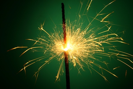 christmas sparkler on green backgroundの写真素材
