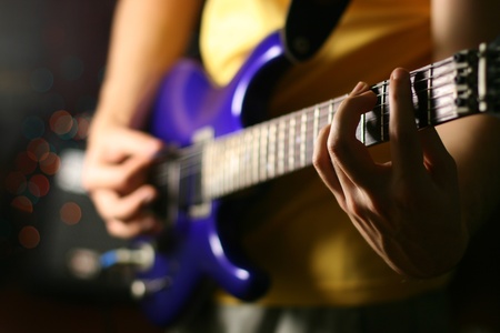 man play solo on blue guitarの写真素材