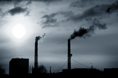 factory smoke emissions pipes in the skyの写真素材