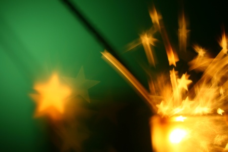 christmas sparkler on green backgroundの写真素材
