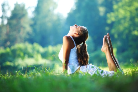 yoga woman on green park background