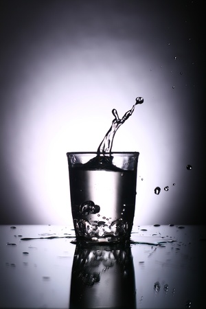 alcohol splash on gray backgroundの写真素材