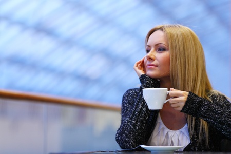  young woman drink coffee on modern backgroundの写真素材