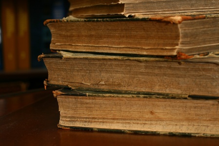 books on table in dark library room