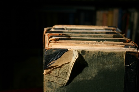 books on table in dark library roomの写真素材