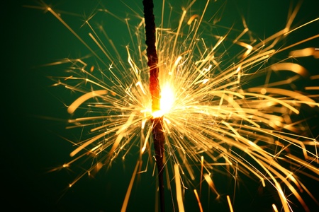 christmas sparkler on green backgroundの写真素材
