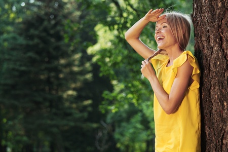 happy woman posing against a background of treesの写真素材