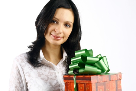 The beautiful young girl with gifts costs and the holiday smiles Christmas new year