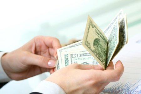 hands counting dollar money on white background