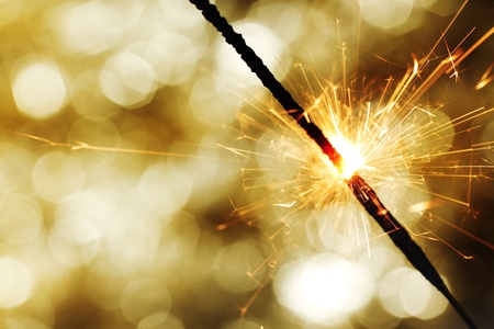 sparkler on gold  bokeh background macro close upの写真素材