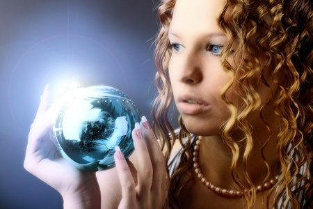 The girl with a magic New Year's sphere is very surprised holidaysの写真素材