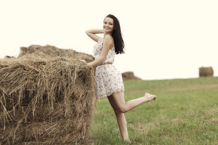 portrait of a girl next to haystackの写真素材