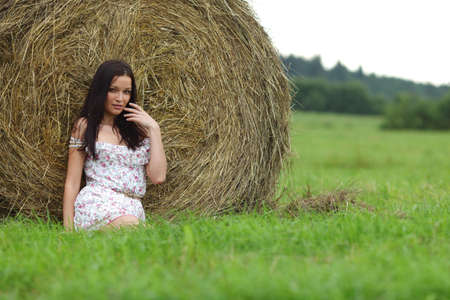 portrait of a girl next to haystack