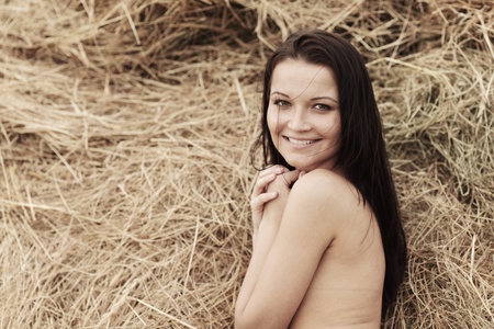portrait of a girl next to haystackの写真素材