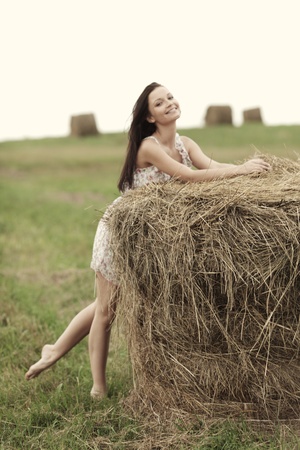 portrait of a girl next to haystackの写真素材