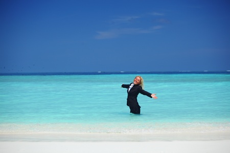 business woman stay in ocean wavesの写真素材
