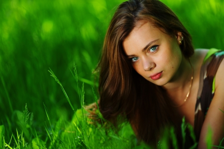 brunette lying on green grassの写真素材