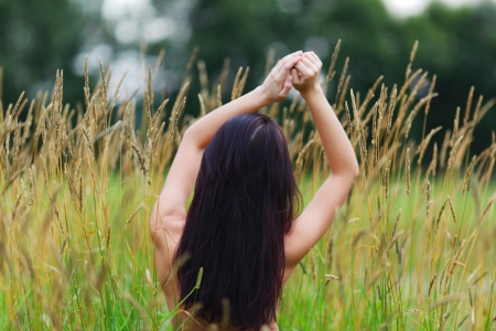 woman on grass field feel freedomの写真素材