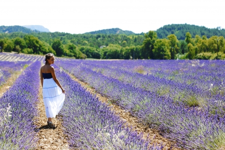 Woman standing on a lavender fieldの写真素材