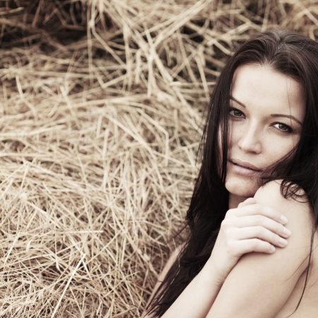 portrait of a girl next to haystackの写真素材