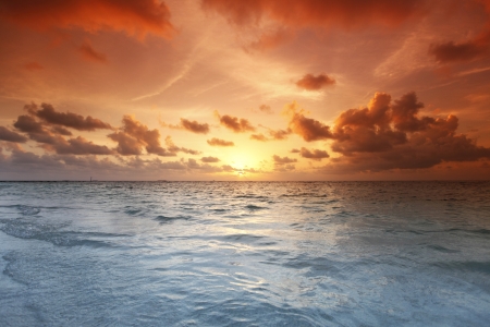 Beautiful view of sea and empty beach on sunsetの写真素材