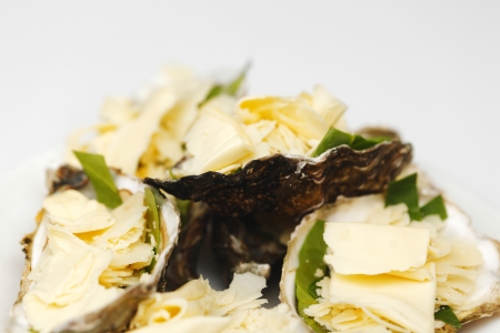 Oysters with cheese and basil isolated on whiteの写真素材