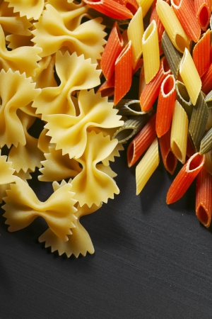 Variety of types and shapes of Italian pasta on black tableの写真素材