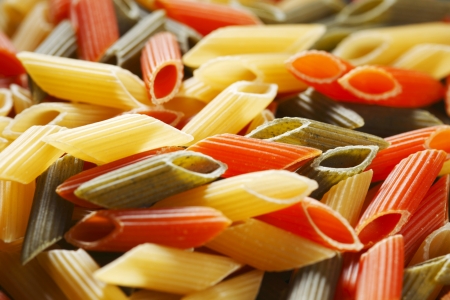 Colored dry italian pasta backgroundの写真素材