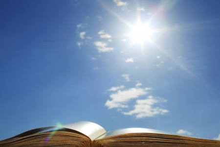  book of wisdom on sun sky backgroundの写真素材