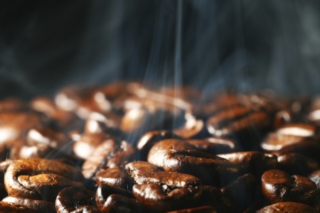 macro coffee beans in aroma smokeの写真素材