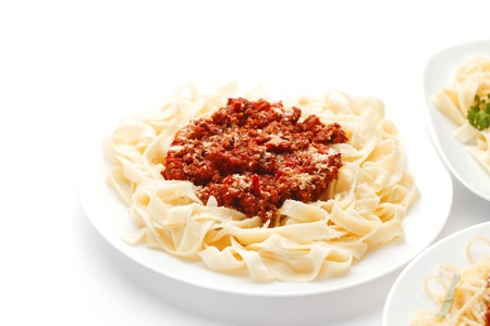 Plates with spaghetti bolognese on white backgroundの写真素材
