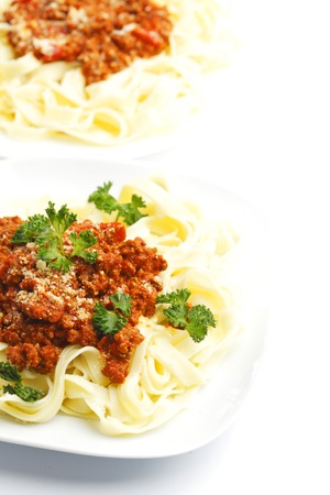Plates with spaghetti bolognese on white backgroundの写真素材