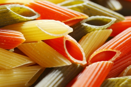 Colored dry italian pasta backgroundの写真素材