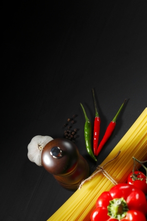 Pasta ingredients on black table, italian cuisine conceptの写真素材