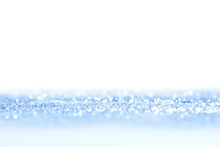 Abstract blue bright sparkles defocused backgroundの写真素材