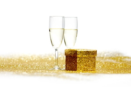 Two glasses of champagne with christmas present and ballsの写真素材