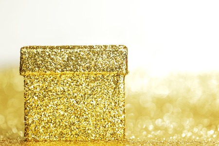 Golden boxes with holiday gifts on shiny glitter backgroundの写真素材