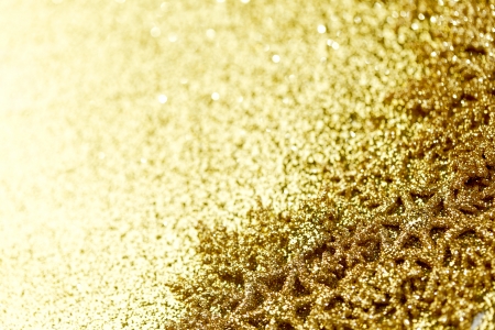 Golden snowflakes on shiny glitter backgroundの写真素材