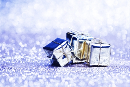 Silver christmas gifts on glitter shiny background close-upの写真素材