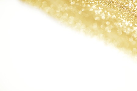 Golden shiny glitter holiday celebration background with white copy spaceの写真素材